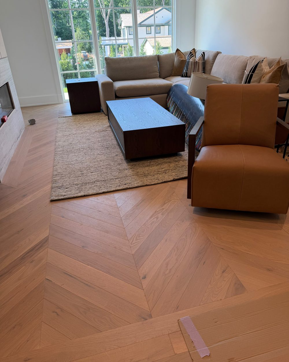 Chevron hardwood flooring in a furnished living room