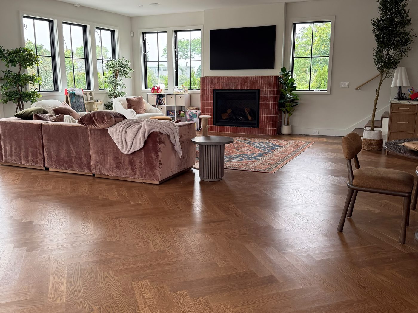 Furnished living room with rich herringbone hardwood flooring